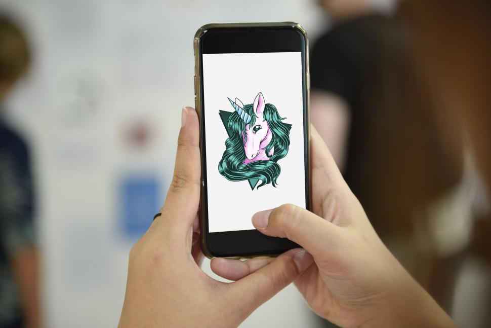 Free Image of Close up of hands holding a mobile phone capturing photograph 