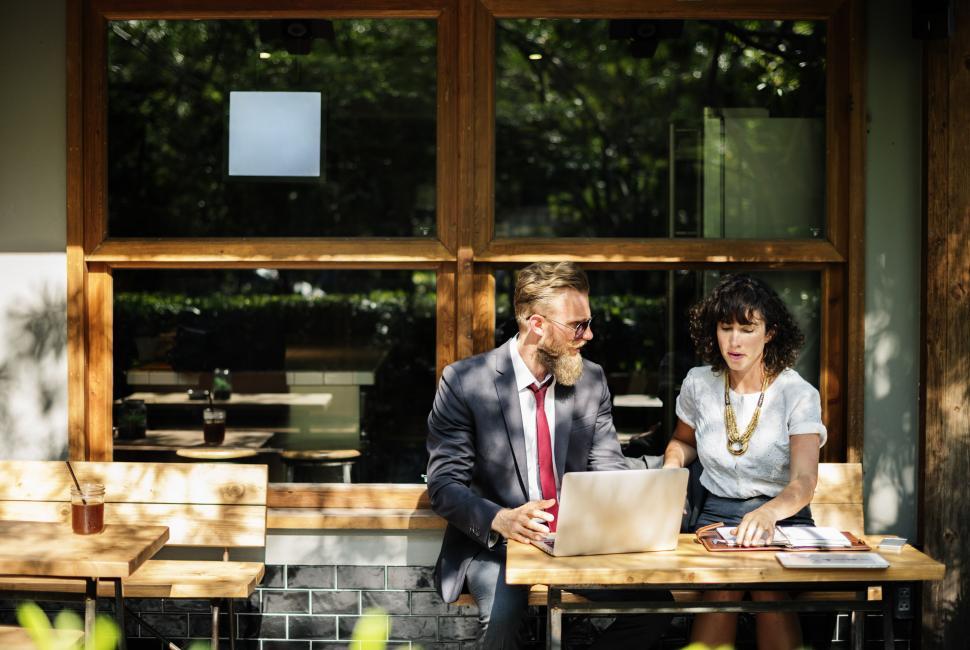 Free Image of Portrait of two business people discussing at an outdoor restaur 