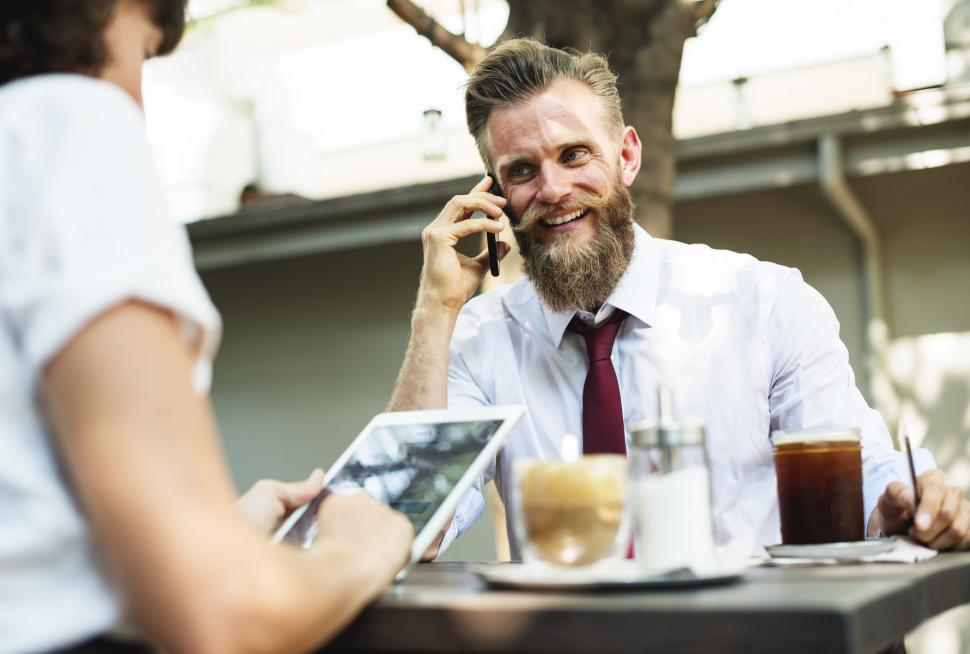 Free Image of Portrait of bearded man talking on the mobile phone at an outdoo 