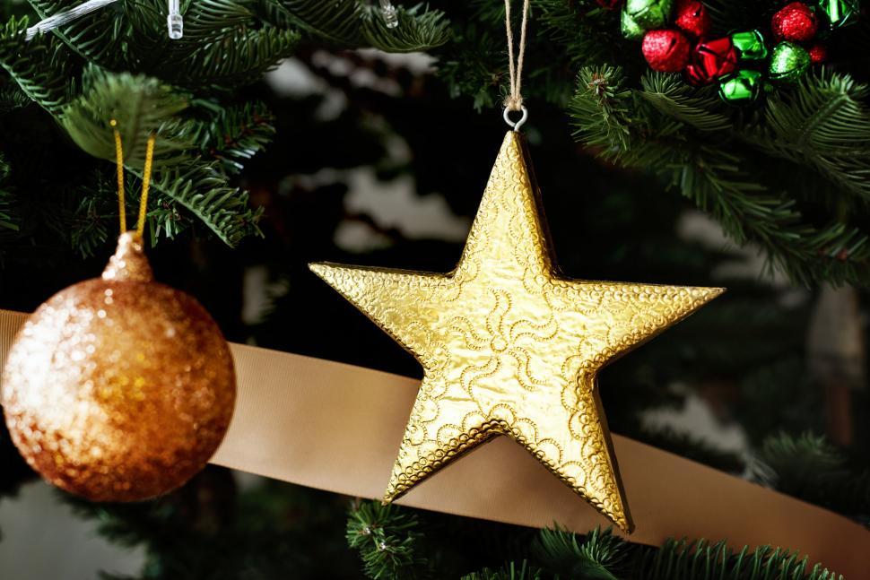Free Image of A golden bauble and a star on the Christmas tree 