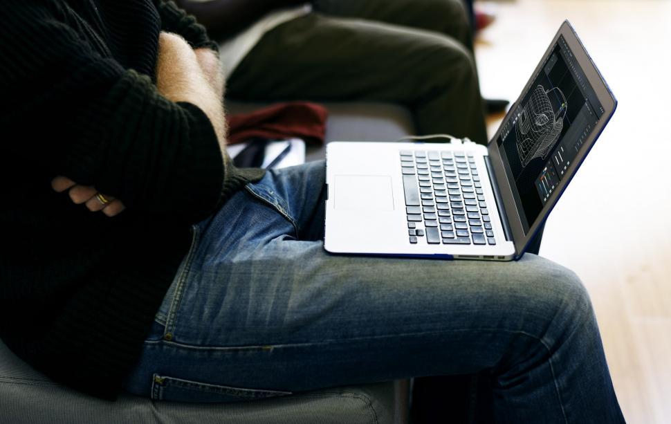 Free Image of An automobile designer sitting with his laptop 