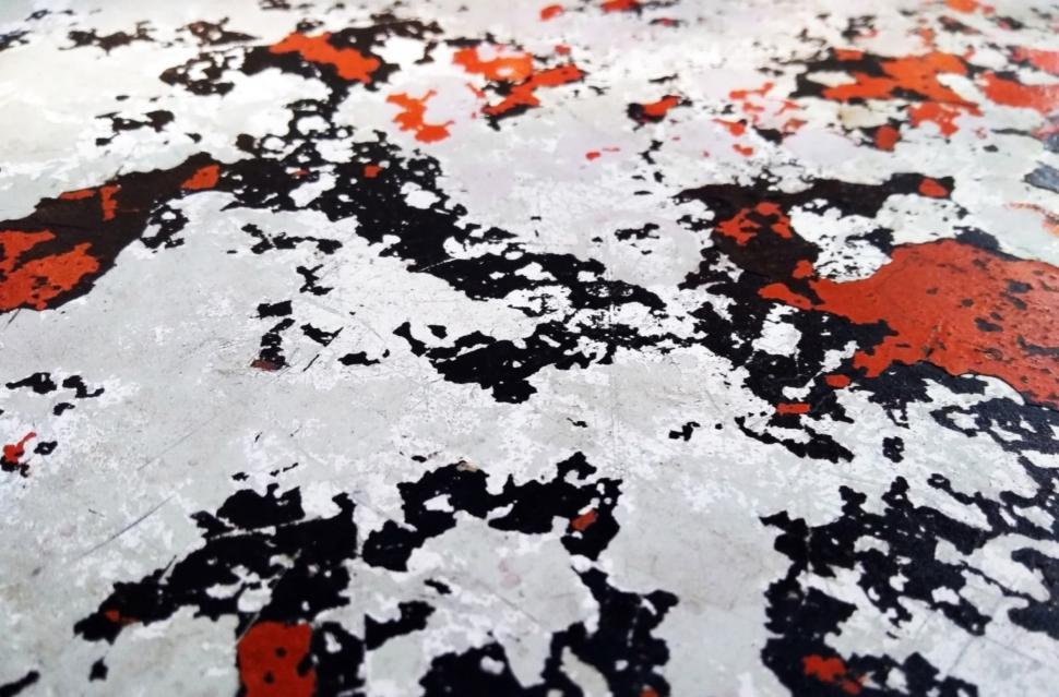 Free Image of Metal texture, scratched with random red and white paint patches  
