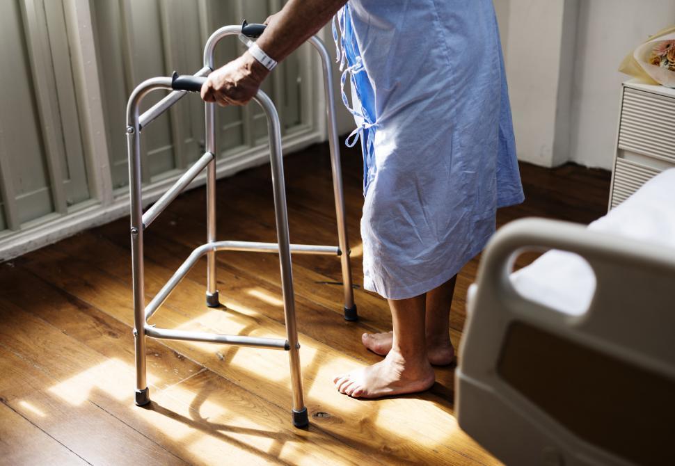 Free Image of A patient holding a walking frame 
