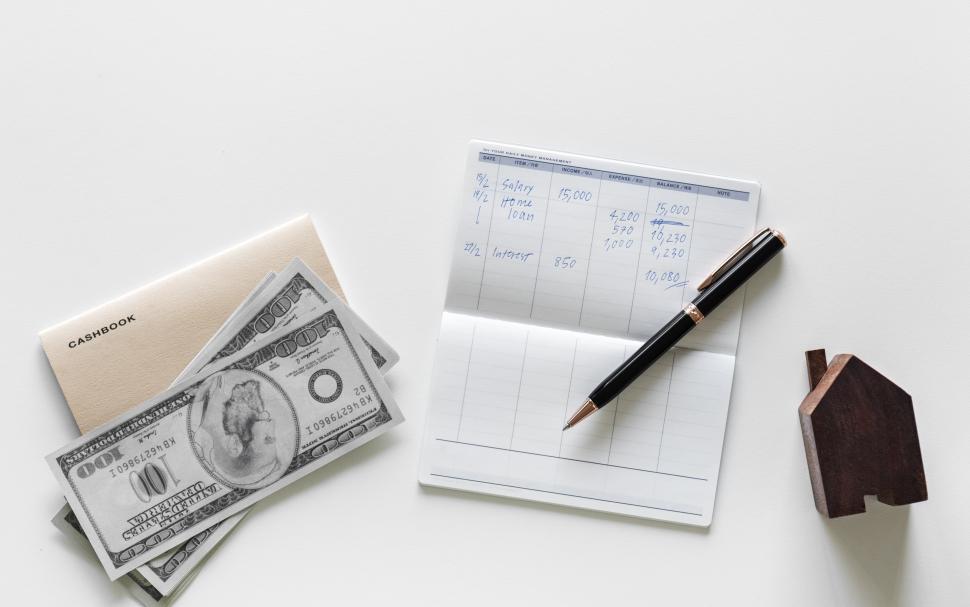 Free Image of Flat lay of cash and a money management statement 