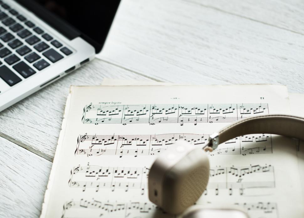 Free Image of Close up of music notes and a headphone 