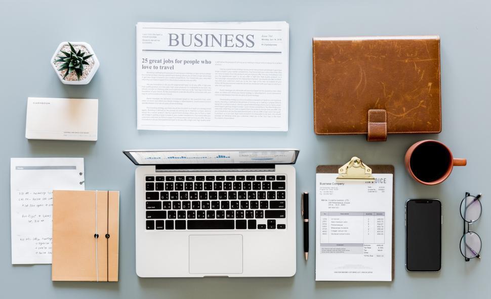 Free Image of Flat lay of a laptop and a coffee mug along with other items on 