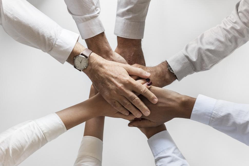 Free Image of Flat lay of hands stacked together in a huddle 