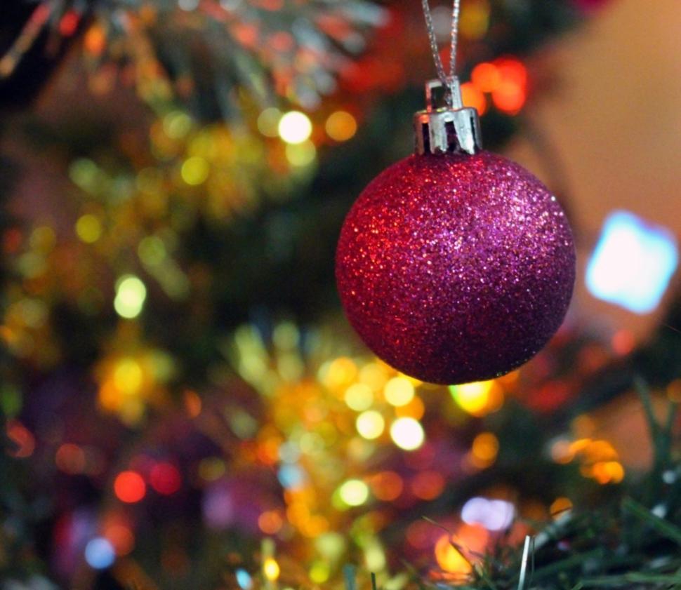Free Image of Festive Background Baubles hanging on a Christmas tree  