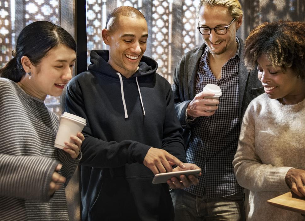 Free Image of Multiethnicity people having fun while looking at their colleague s mobile phone screen 