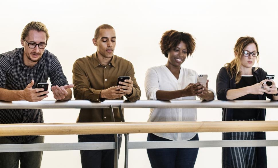 Free Image of Multiethnicity colleagues looking at their mobile phones 