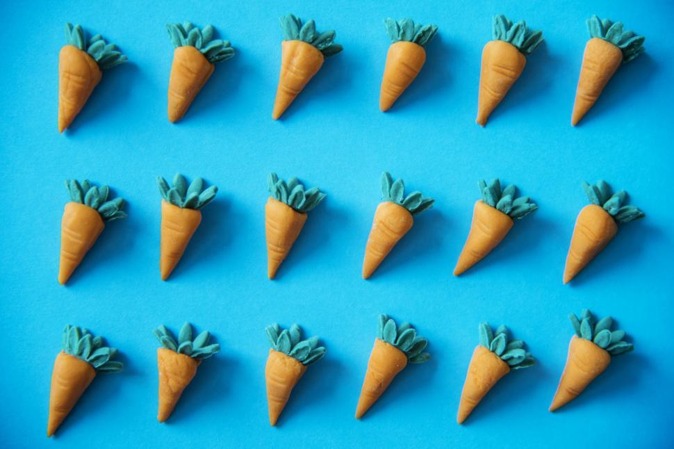 Free Image of Artificial clay carrots on blue background 