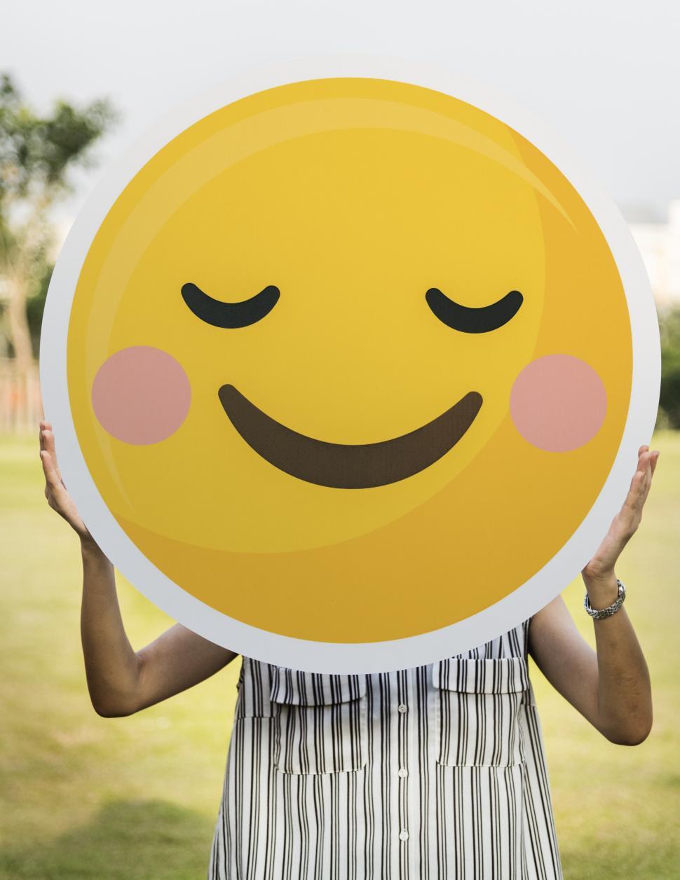 Free Image of Close up of a smiley cut out in a person s hand 