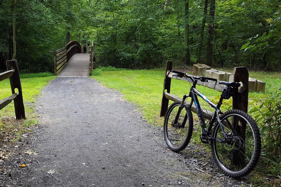 Free Image of Mountain Bikes By A Fence 