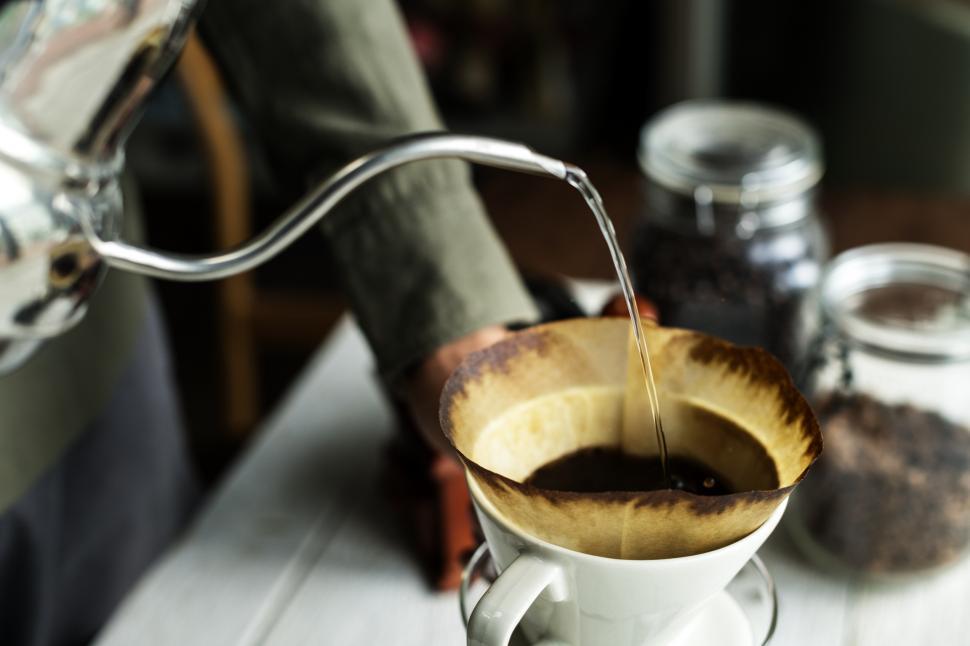 Free Image of Close up of hot water being poured over coffee filter cone 