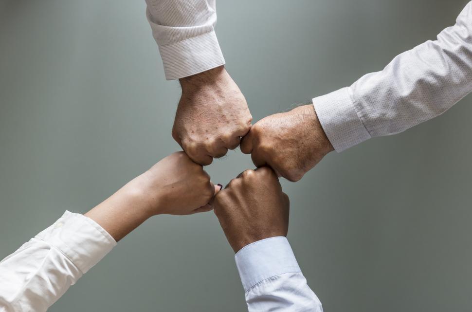 Free Image of Flay lay of hands giving Fist Bump in agreement 