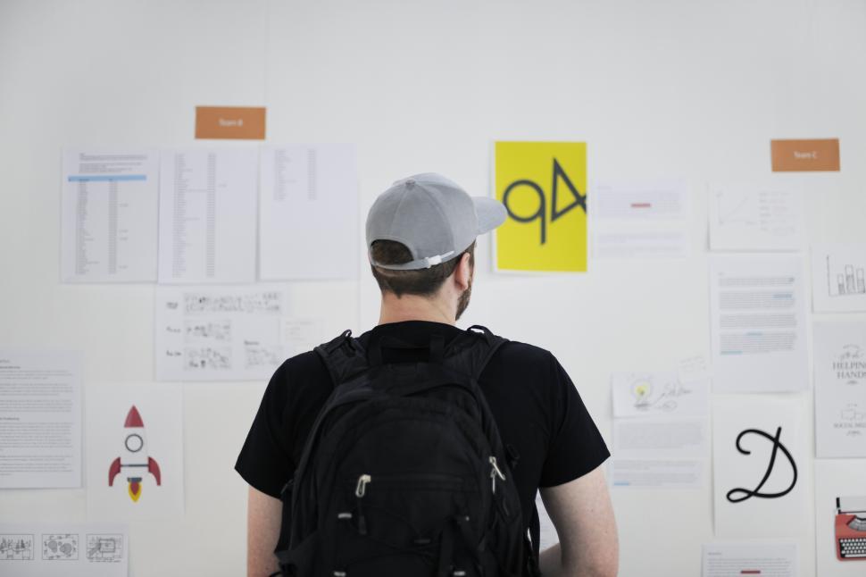 Free Image of Back view of a young man looking at the charts 