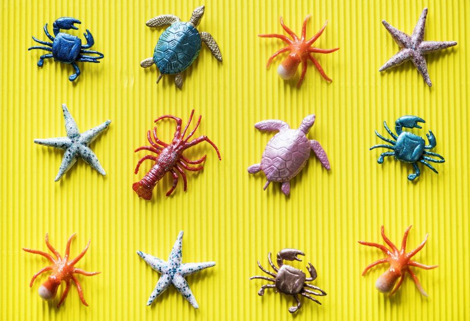 Free Image of Flat lay of toy sea animals on yellow surface 