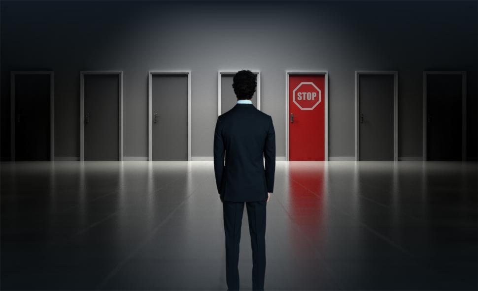 Free Image of Man Facing Door with Stop Sign - Forbidden Concept 