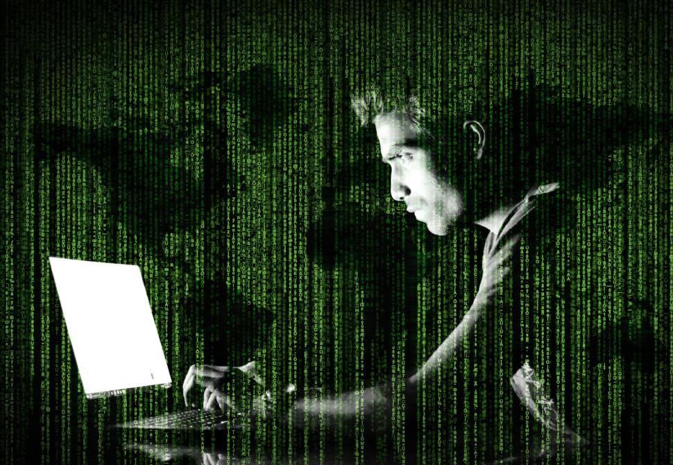 Free Image of Hacker Over Screen with Code and World Map 