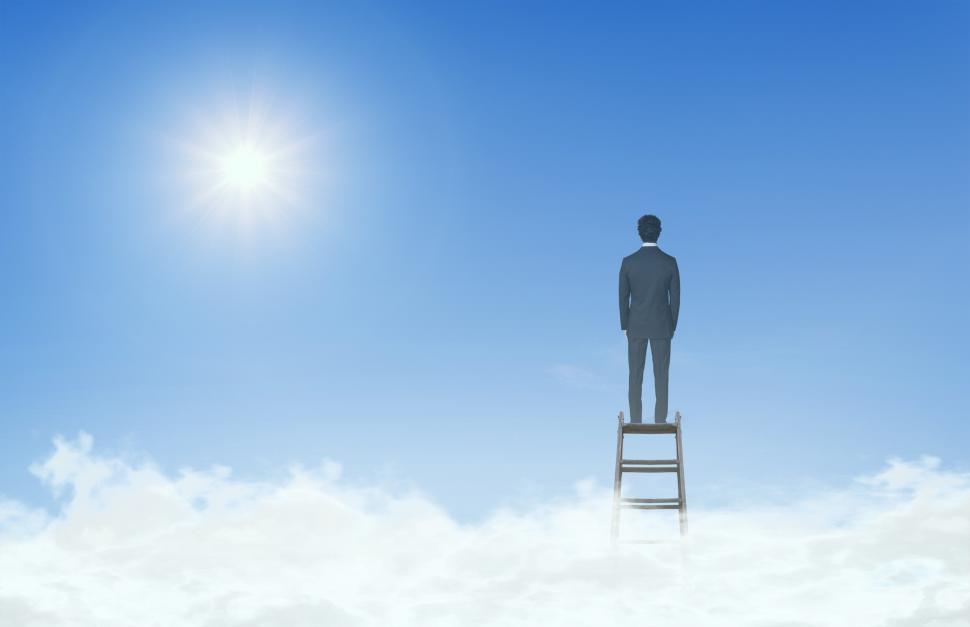Free Image of Businessman On Top of Ladder Above the Clouds 
