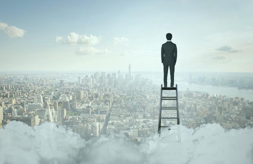 Free Image of Businessman On Top of Ladder Overlooking Manhattan 