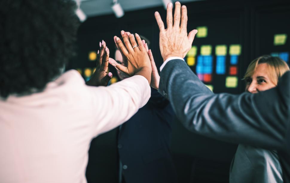 Free Image of Coworkers giving high five at a gathering 