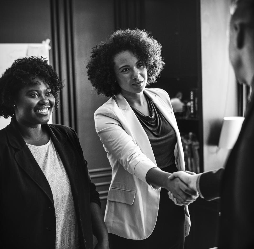 Free Image of Three colleagues in the office close serious deal 
