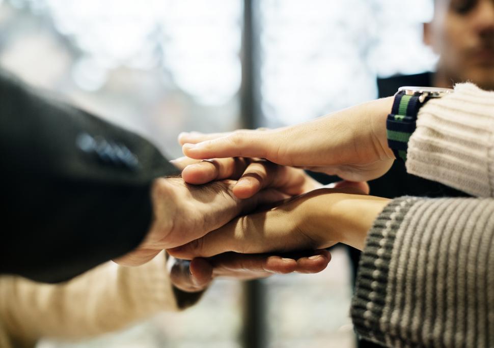 Free Image of Hands of team stacked together in a meeting 
