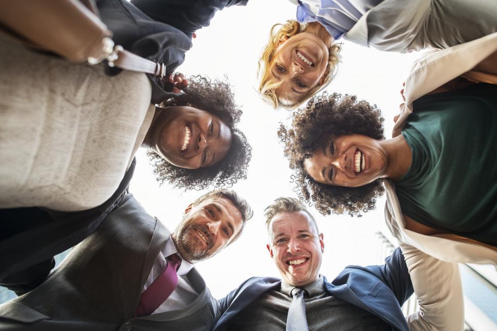 Free Image of Low angle view looking up at a happy team huddle 