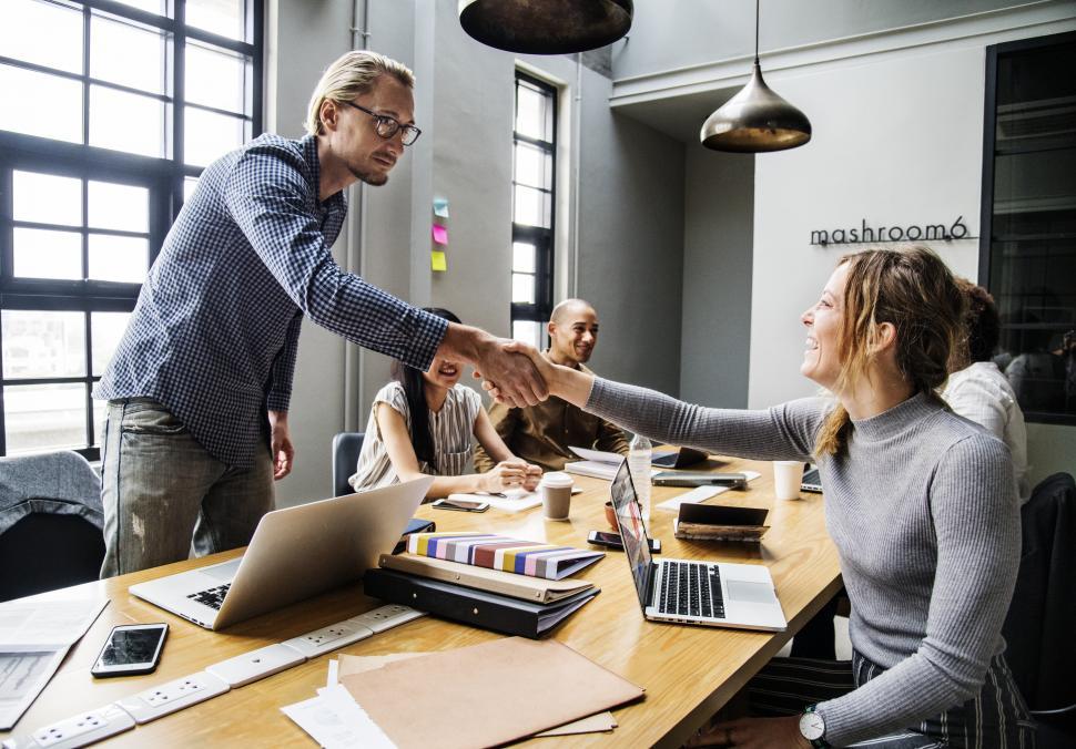 Free Image of Handshake across table between two business people 