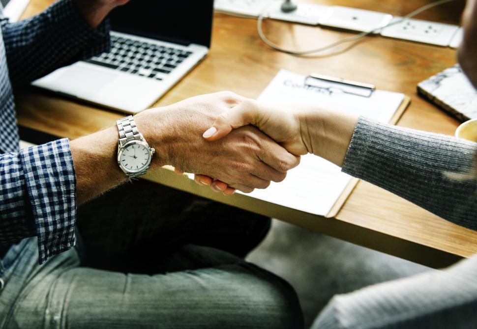 Free Image of Seated people shaking hands 