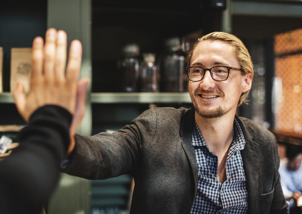 Free Image of Happily giving high five in the office 