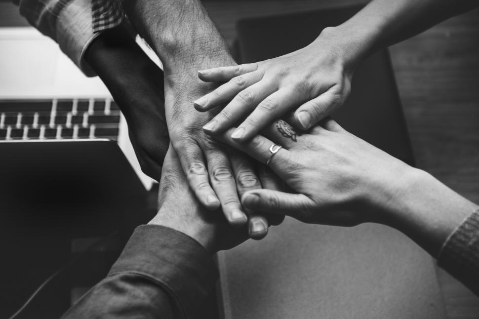 Free Image of Hands stacked together, black and white image 