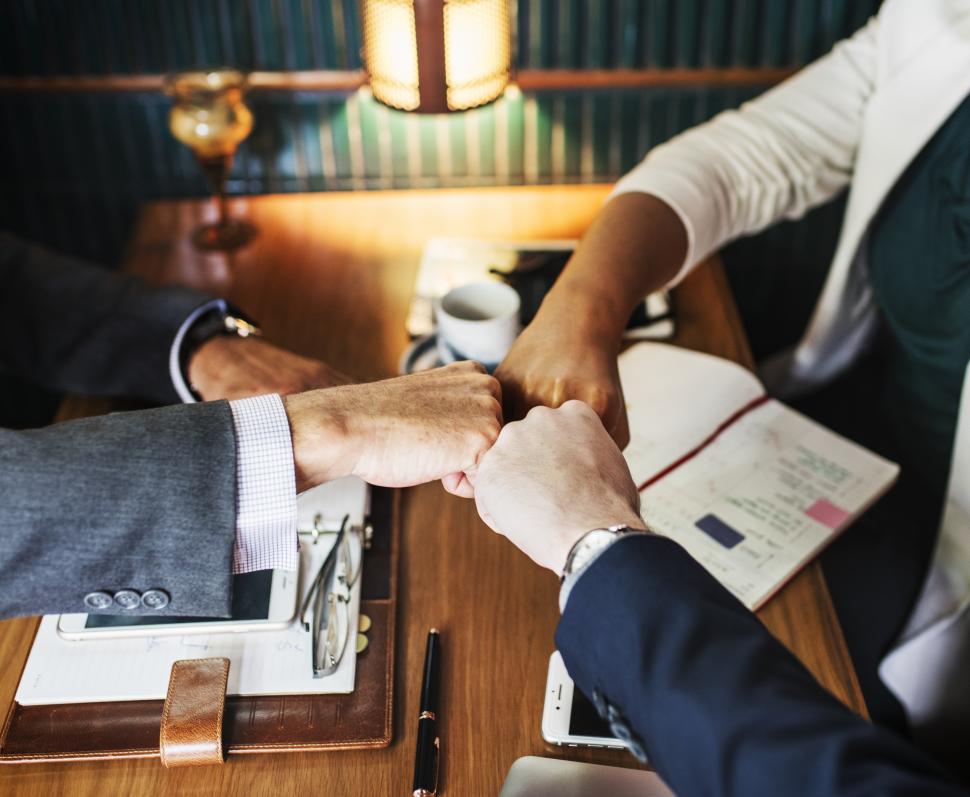 Free Image of A business team giving Fist Bump in agreement over coffee 