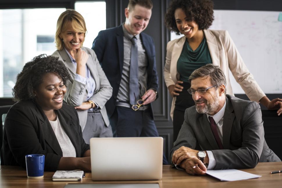 Free Image of Gathered around a laptop in a meeting 