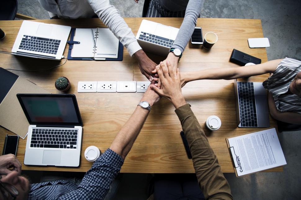 Free Image of Table meeting with hands stacked together 