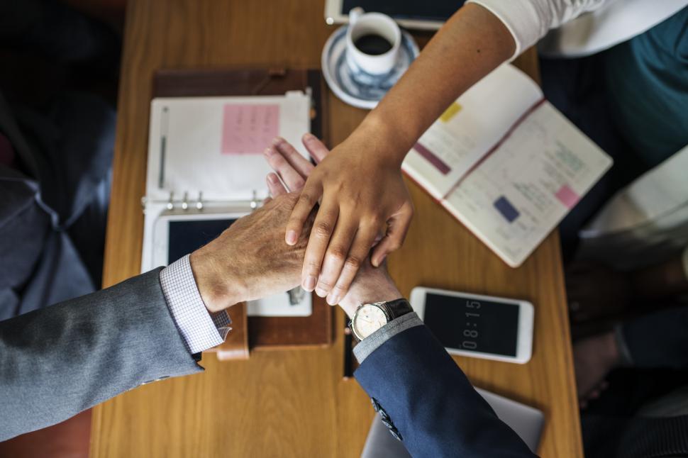 Free Image of Three hands stacked together after a meeting 