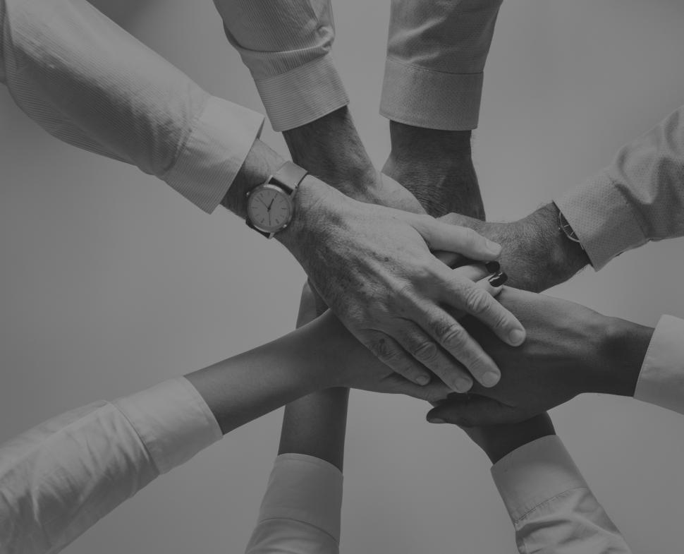 Free Image of Black and white of hands stacked together 