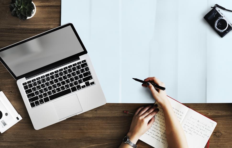 Free Image of Overhead view of a persons hands and a laptop on the table 