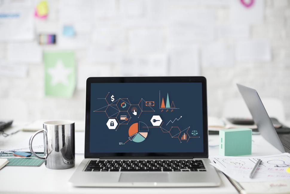Free Image of A laptop along with a steel mug the table 