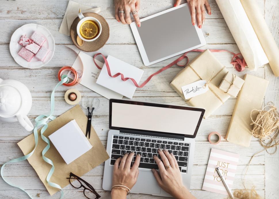 Free Image of Overhead view of women s hands working on laptop and tablet PC 