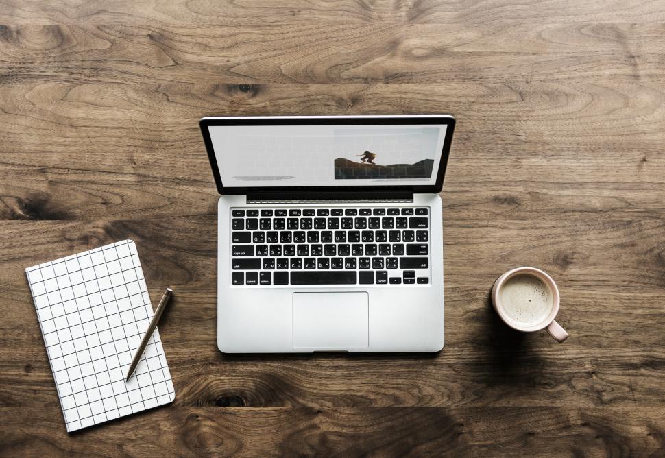 Free Image of Flat lay of a laptop on wooden on surface 