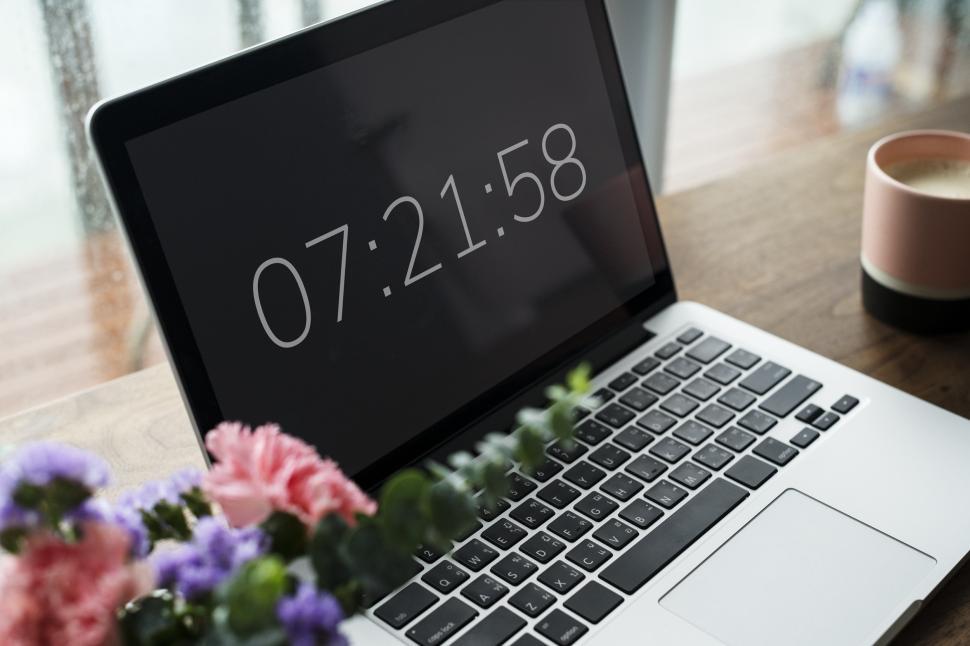 Free Image of Close up of a laptop on the table displaying time 