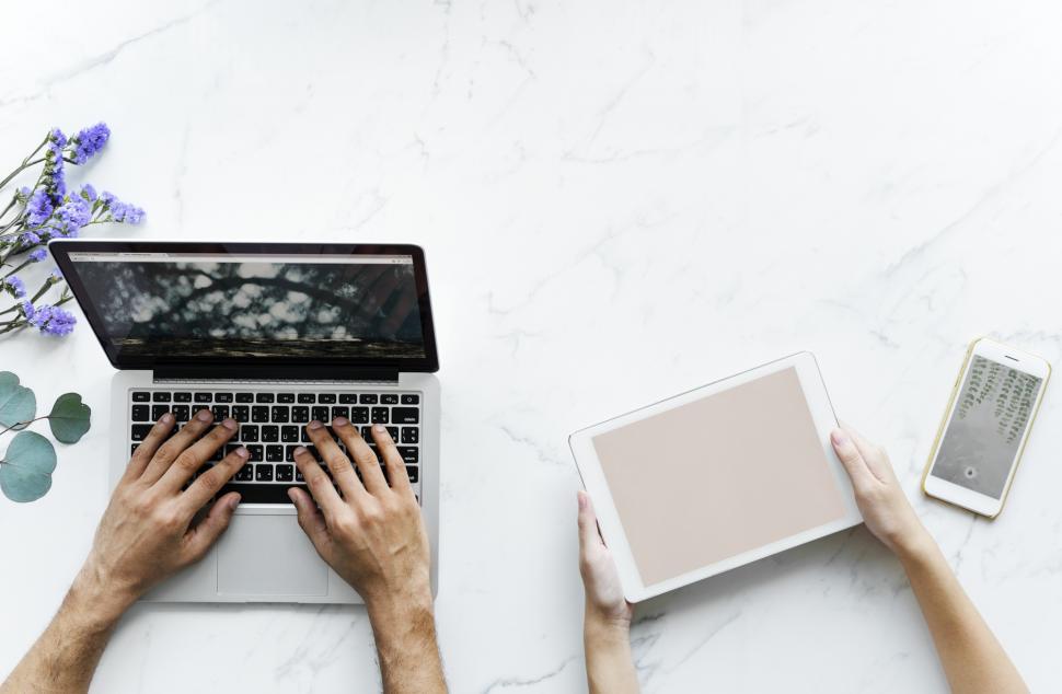 Free Image of Hands operating laptop and a tablet PC 