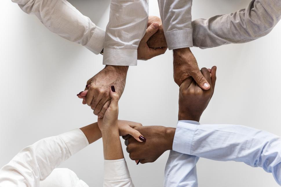 Free Image of Hands crossed holding each other in a group 