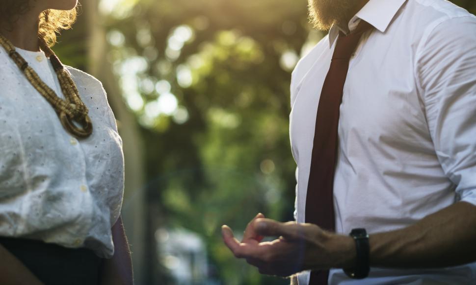 Free Image of A bearded man talking and a woman talking to each other 