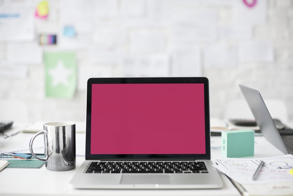 Free Image of A laptop along with a steel mug on the table 