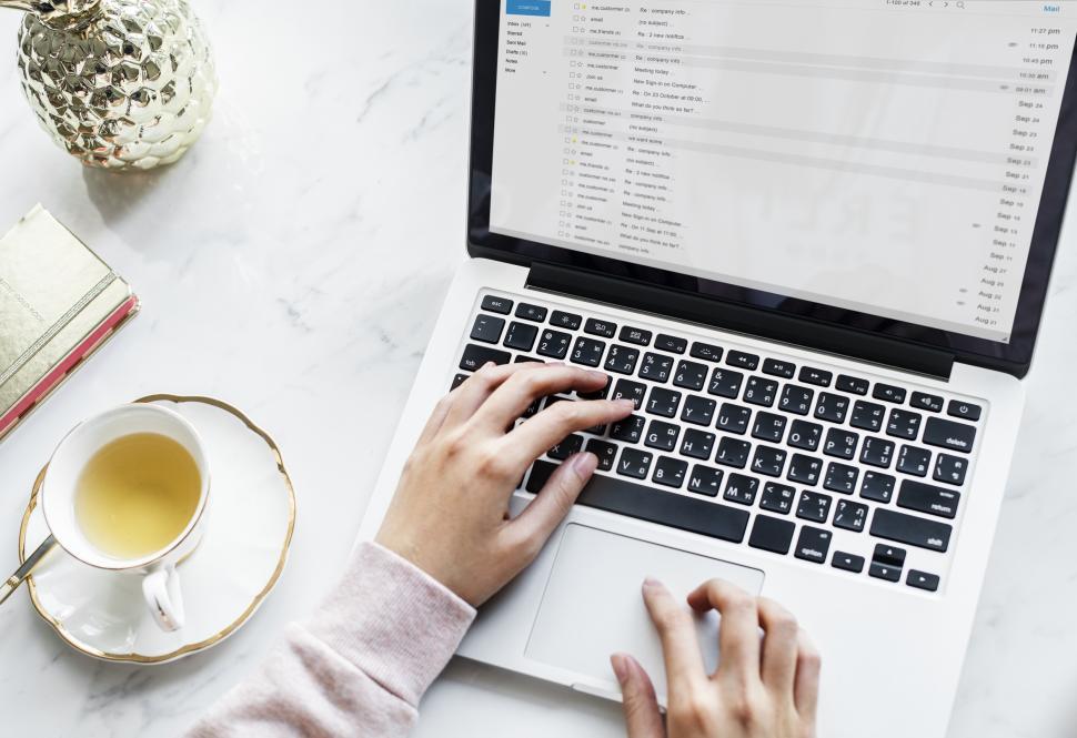 Free Image of Overhead view of hands typing on laptop 