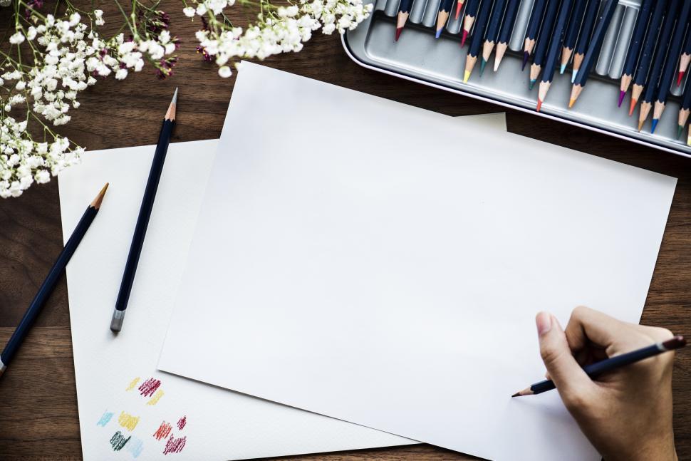 Free Image of Overhead view of a hand drawing on white paper 