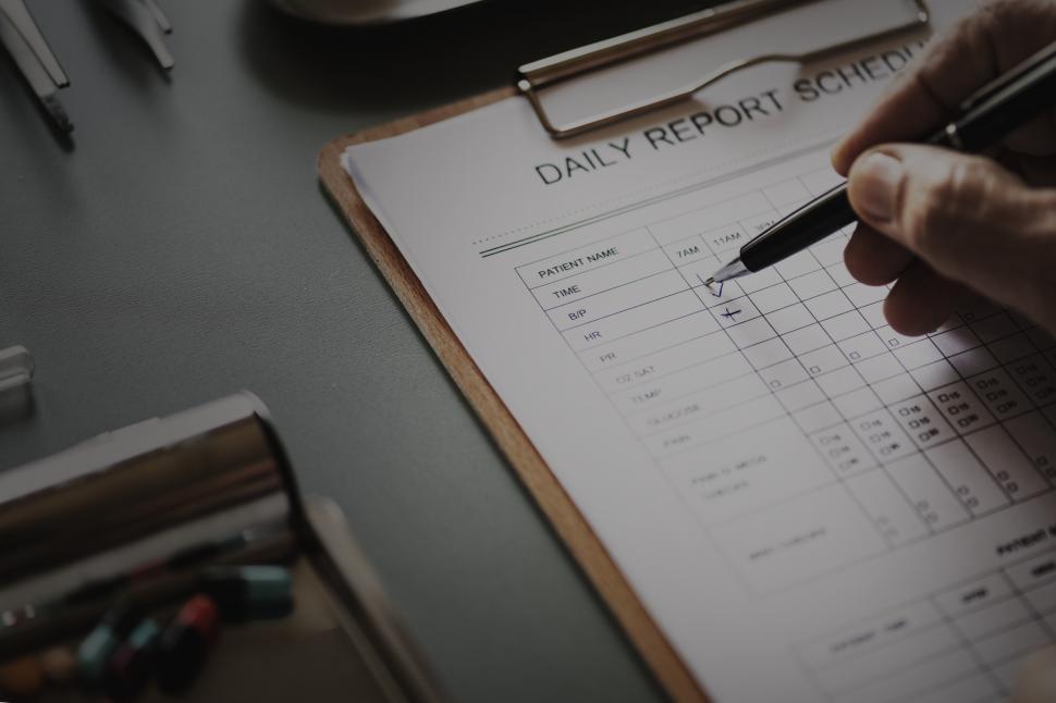 Free Image of Close up of a doctor s hand checking schedule 